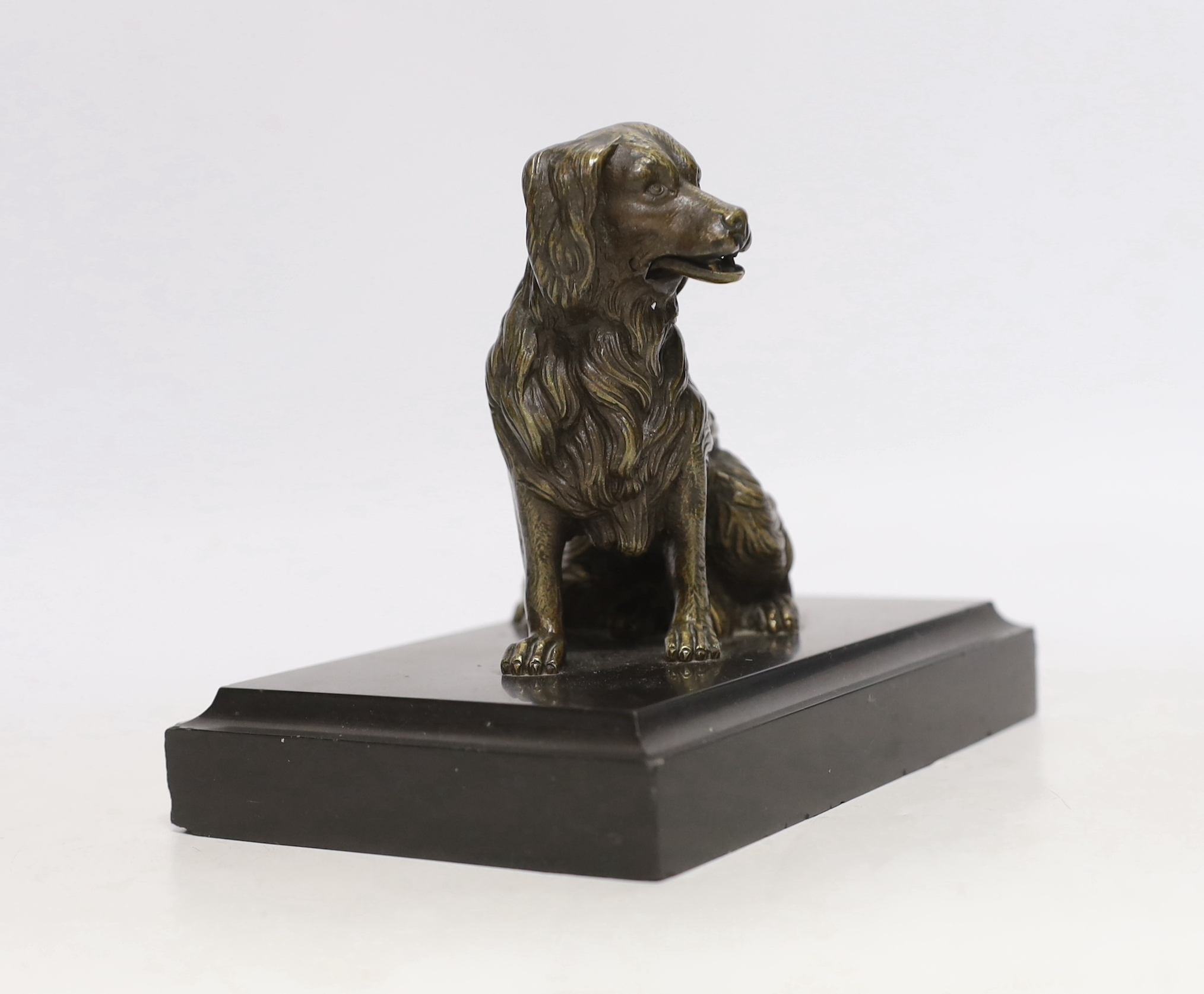 A 19th century French bronze dog card holder with articulated jaw, raised on a slate base, 18cm wide